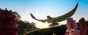 Seahawk statue on campus with flowers