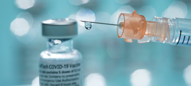 Bottle of COVID-19 vaccine with syringe