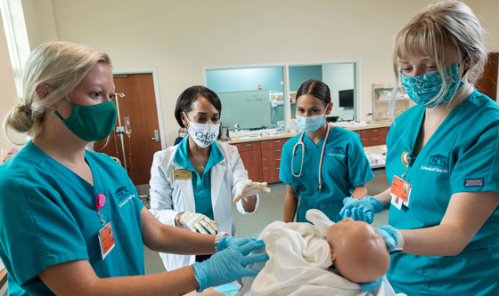 Nursing faculty and students in the lab