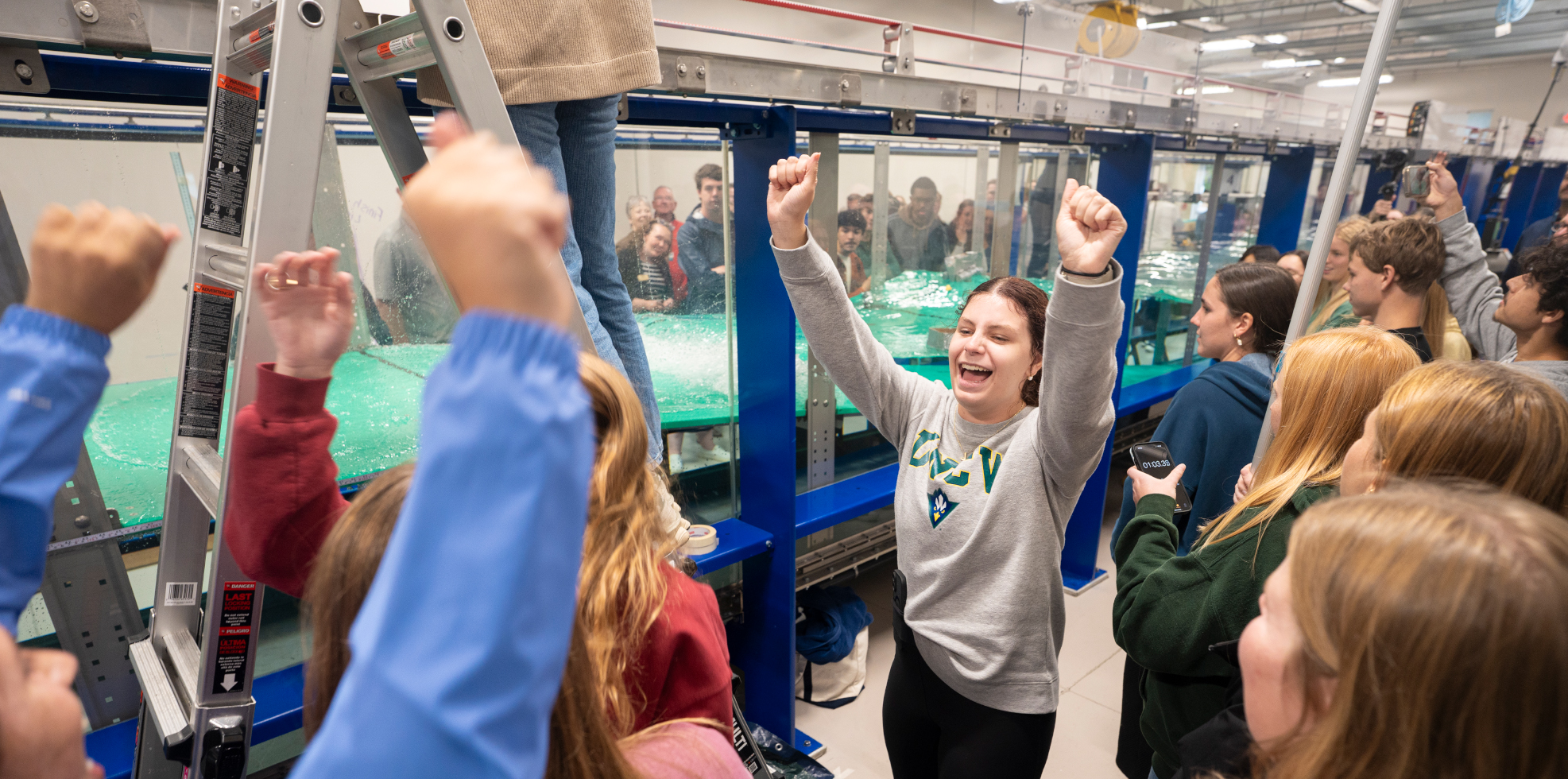 students cheering at wave flume boat race