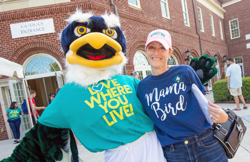 Sammy C. Hawk with parent wearing t-shirt that says, "Mama Bird" during UNCW Move-In