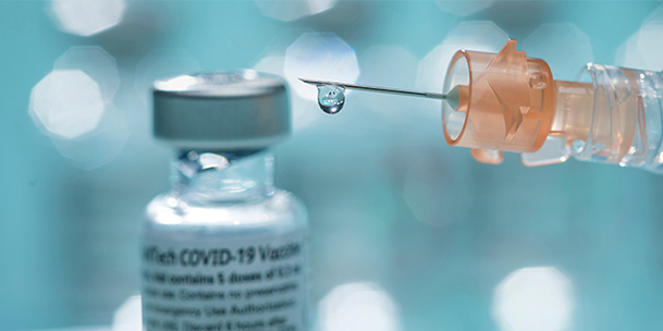 bottle of COVID-19 vaccine with syringe