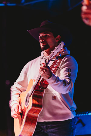 Arendt preforming with a guitar