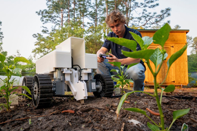 Samuel Stasiewicz '26 with SanaSolo, a robot that monitors soil fertility