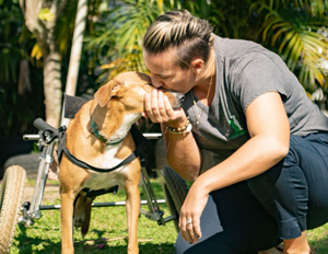 Casey Quimby showing kindness to handicapped dog